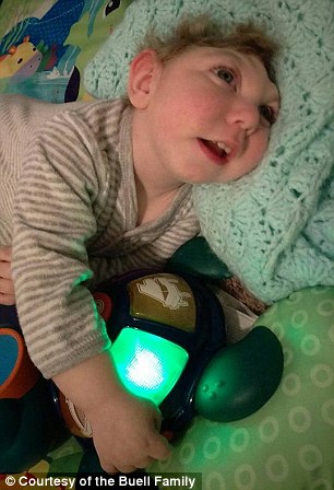 Jaxon with his favorite toy, a blue turtle
