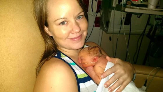Jaxon in the arms of his mother's Brittanny